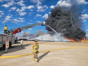 Two people putting out a fire