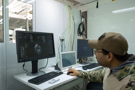 A biomedical equipment technician at the U.S. Army Medical Materiel Agency’s Medical Maintenance Operations Division in Tracy, California, performs maintenance on a computed tomography machine. (Photo Credit: Katie Ellis-Warfield)