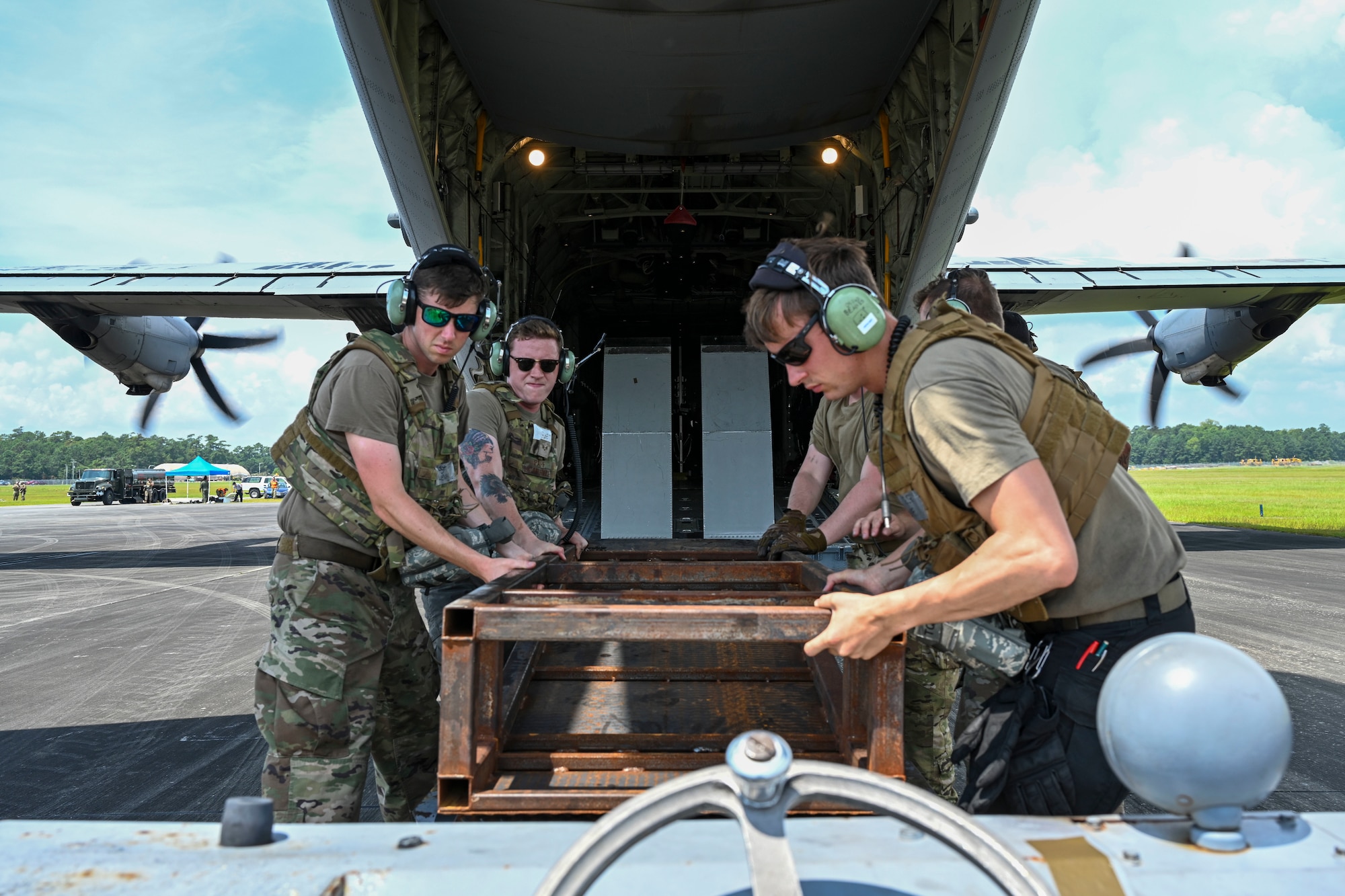 Loadmasters with the 41st Airlift Squadron offload equipment from a C-130J Super Hercules