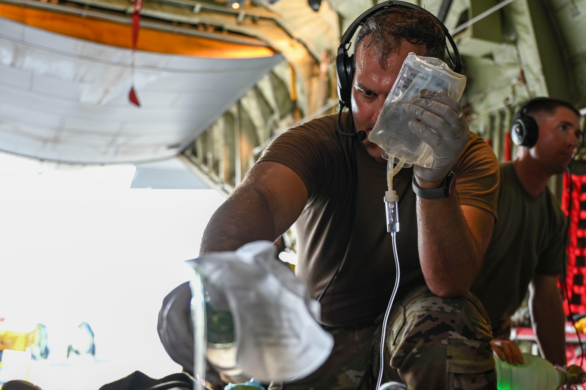 An Airman with the 445th Aeromedical Evacuation Squadron provides care to a simulated patient as part of a mass casualty scenario