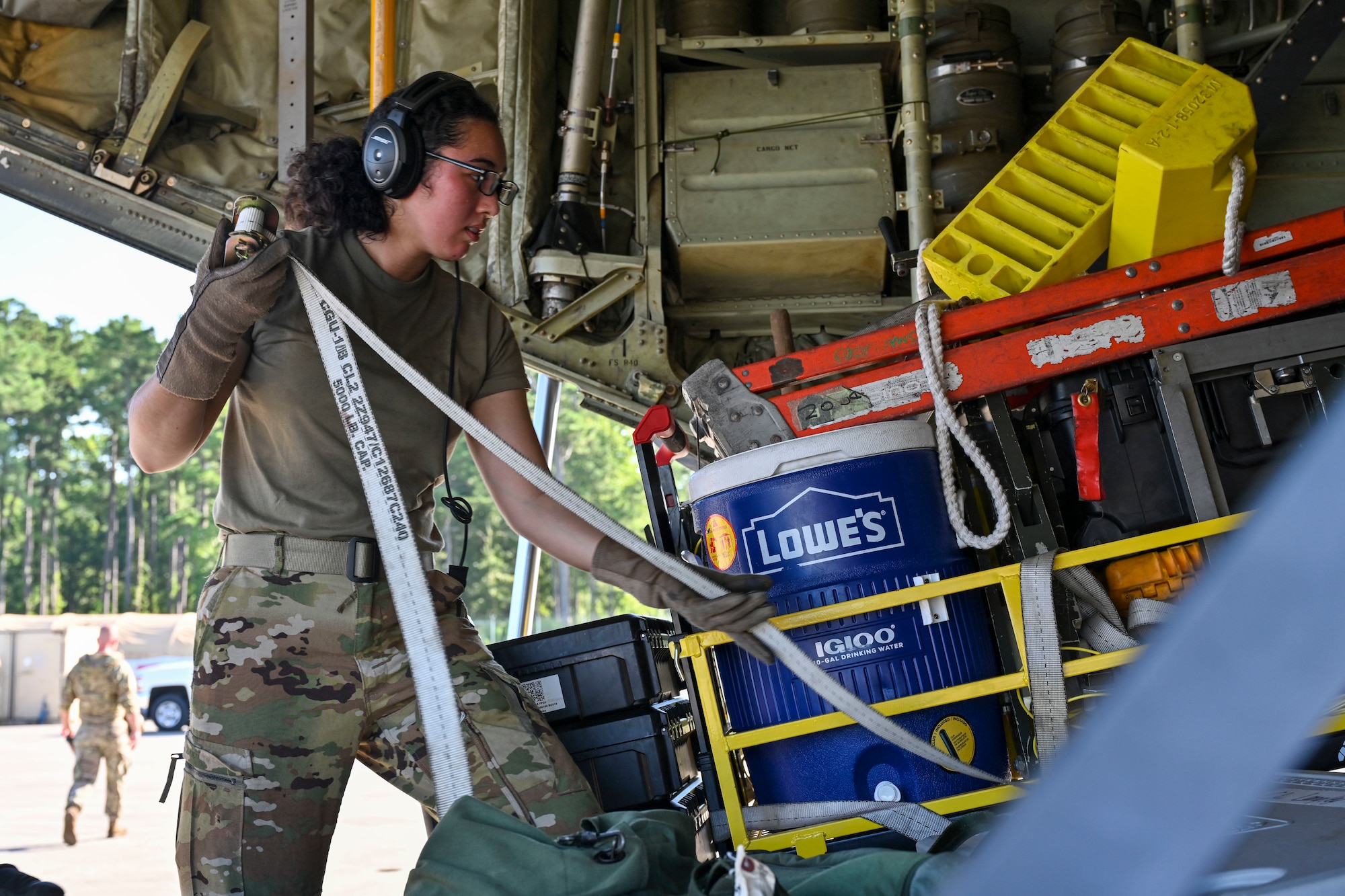 Airman 1st Class Candis Ruiz, 41st Airlift Squadron loadmaster, secures equipment to the ramp of a C-130J Super Hercules