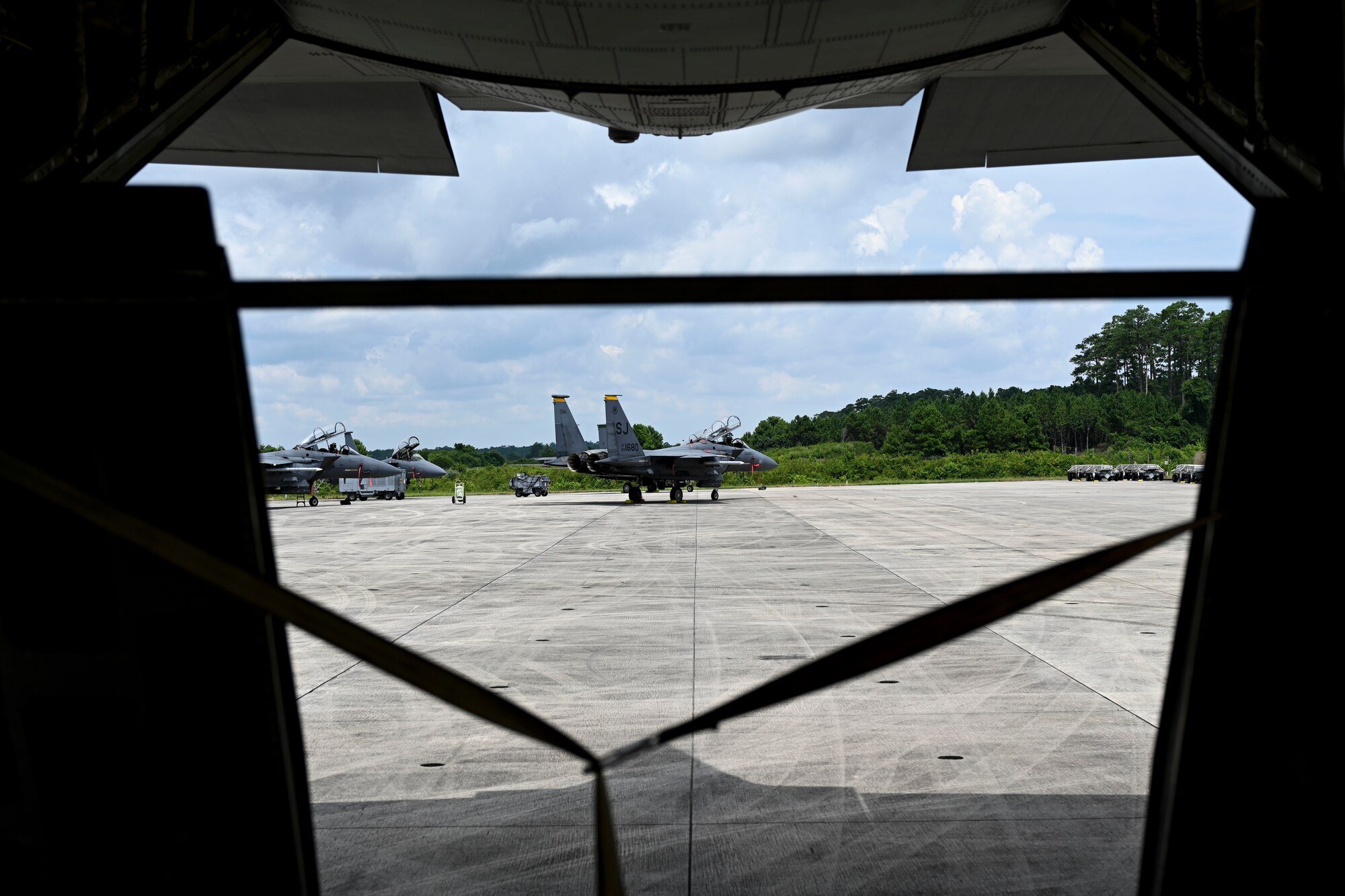 An F-15 Strike Eagle is seen from the back of a C-130J Super Hercules