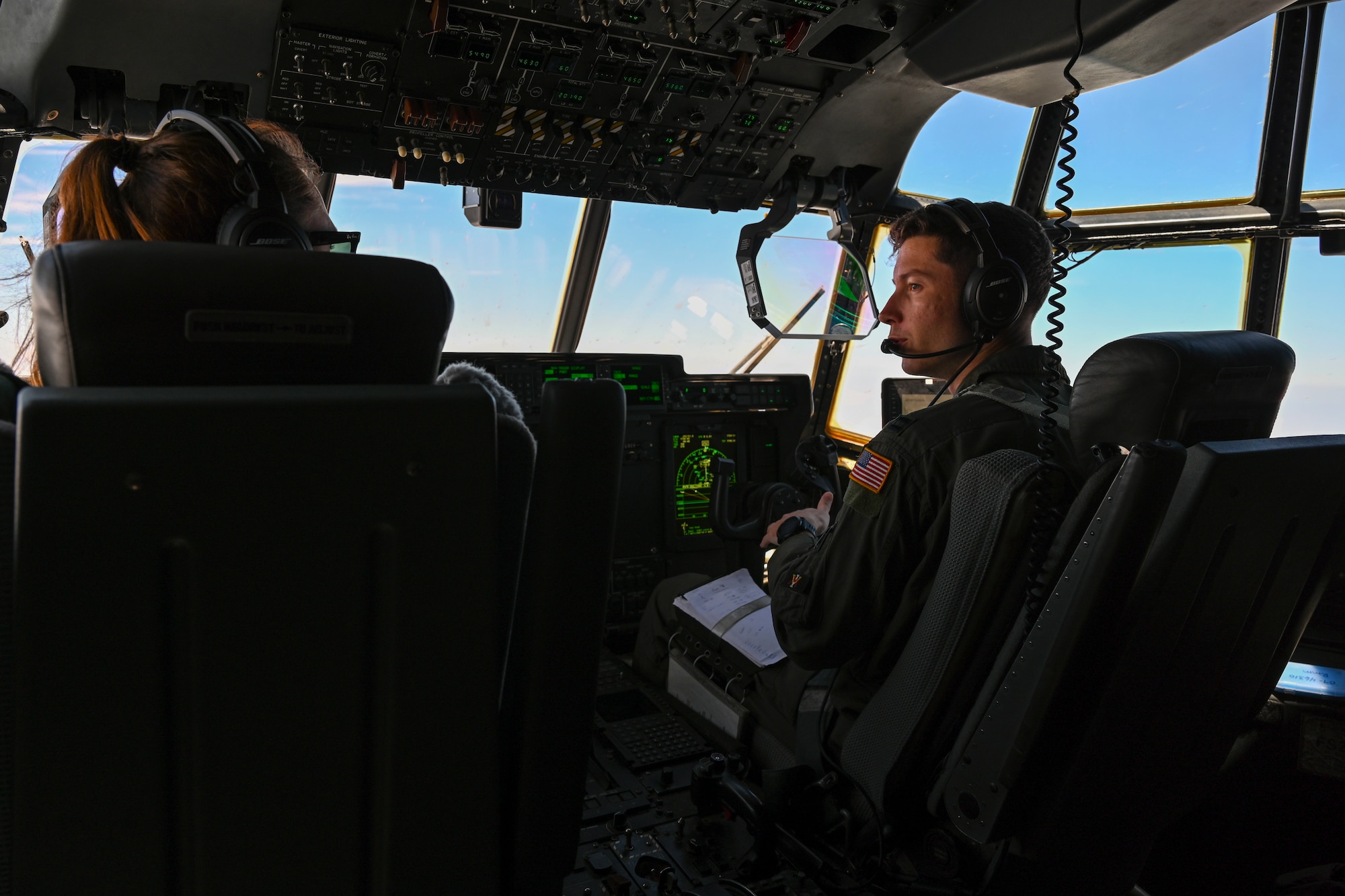 1st Lt. Victoria Pleus and Capt. John Wood, 41st Airlift Squadron pilots, fly a C-130J Super Hercules