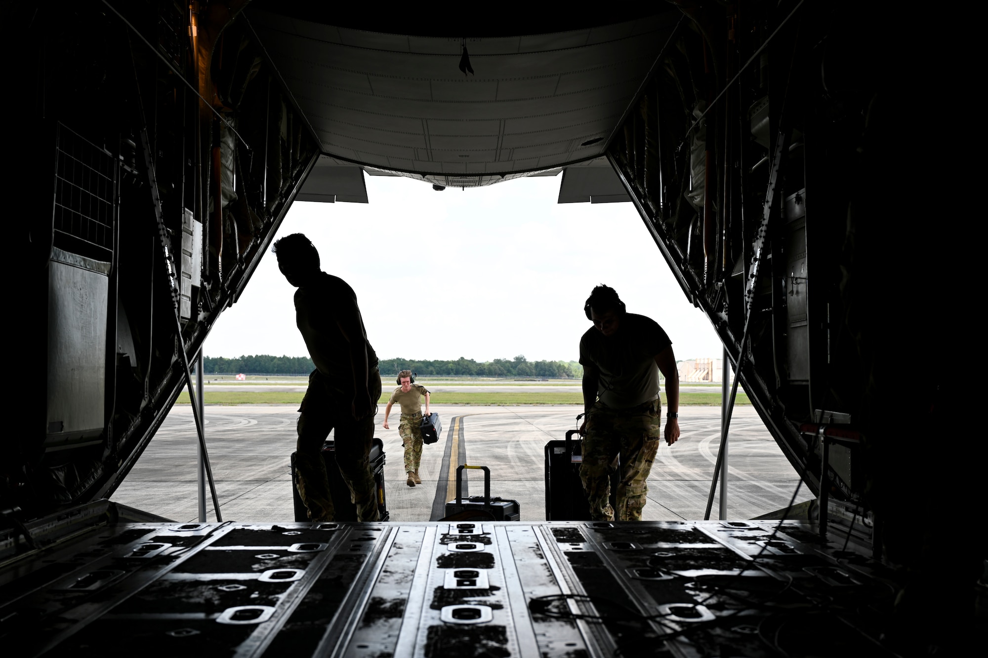 Loadmasters with the 41st Airlift Squadron load equipment onto a C-130J Super Hercules