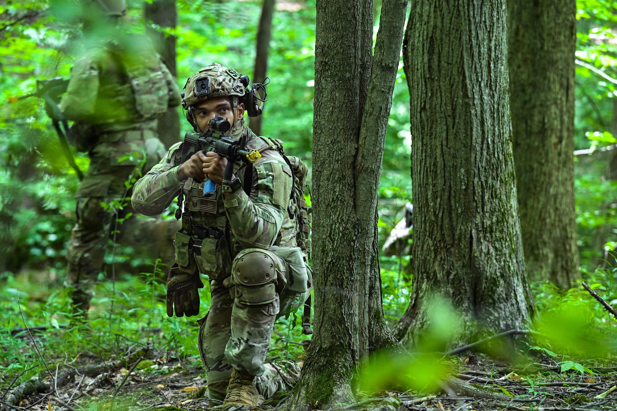 Tech. Sgt. Kyle Keusch, a Defender assigned to the Patrick Space Force Base, Florida's 920th Security Forces Squadron, covers for a fellow Defender to regress during an Integrated Defense Leadership Course training exercise on July 24, 2023, at Camp James A. Garfield Joint Military Training Center, Ohio.