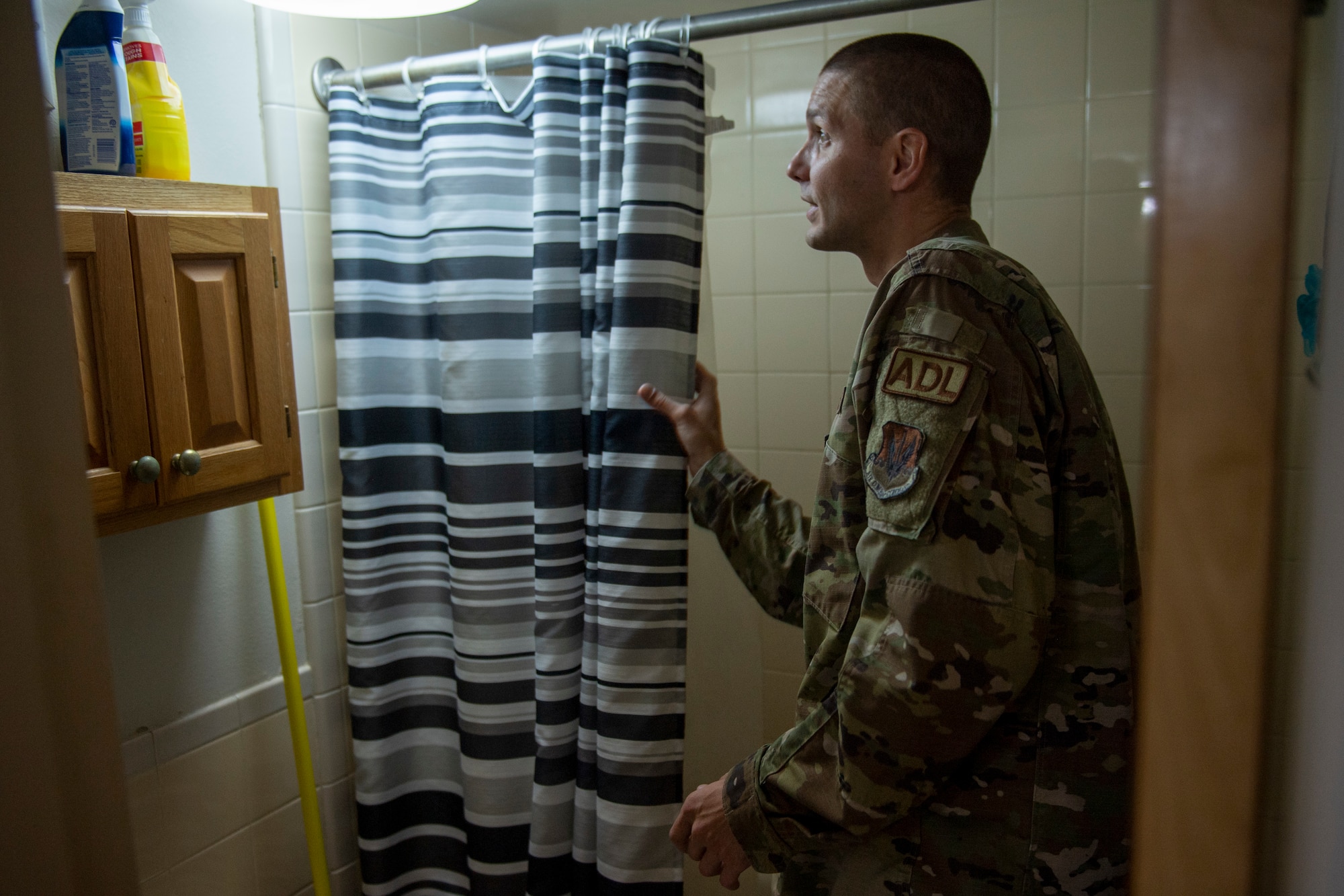 U.S. Air Force Staff Sgt. Chris Goble, 23rd Civil Engineer Squadron airman dorm leader inspects a dorm shower at Moody Air Force Base, Georgia, July 11, 2023. Dorm residents must pass a thorough inspection before being allowed to out-process the dorms. (U.S. Air Force photo by Airman 1st Class Leonid Soubbotine)