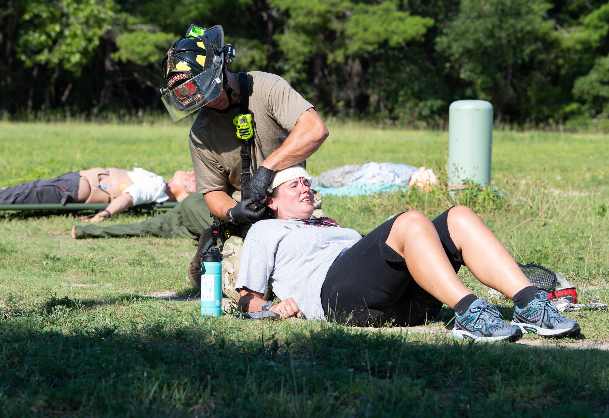 U.S. Air Force Senior Airman Tyler Ghent, 96th Civil Engineer Group firefighter, treats a head injury of a mock casualty.
