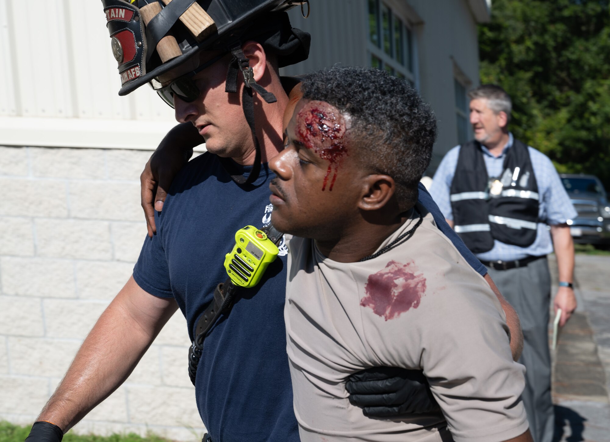 Kyle Vaughn, 96th Civil Engineer Group fire captain, leads a mock casualty to triage after a simulated explosion as part of a training exercise.