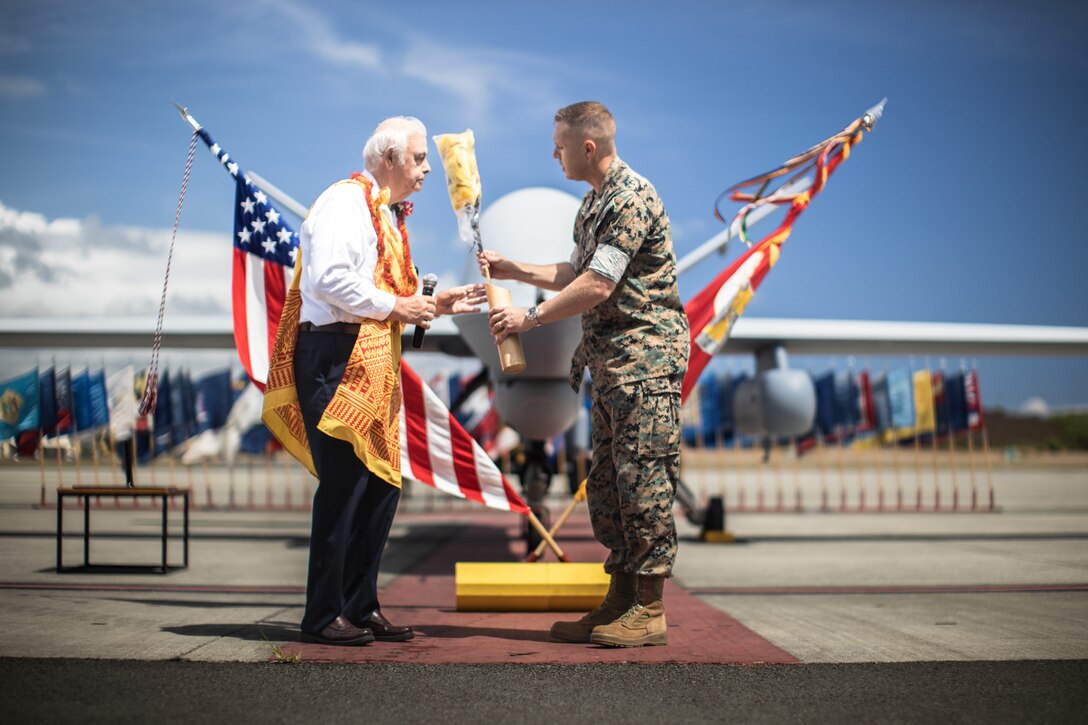 U.S. Marine Corps Lt. Col. Nicholas B. Law receives a Hawaiian feather Kahili during a ceremony for Marine Unmanned Aerial Vehicle Squadron 3 (VMU-3), Marine Aircraft Group 24, 1st Marine Aircraft Wing at Marine Corps Air Station Kaneohe Bay, Aug 2, 2023. The ceremony commemorated the squadron’s years of dedicated effort and work to reach Initial Operational Capability with the MQ-9A. VMU-3 can support the Marine Air-Ground Task Force by providing multi-surveillance and reconnaissance, data gateway and relay capabilities, and enabling or conducting the detection and cross cueing of targets and facilitating their engagement during expeditionary, joint and combined operations.(U.S. Marine Corps photo by Cpl. Christian Tofteroo)