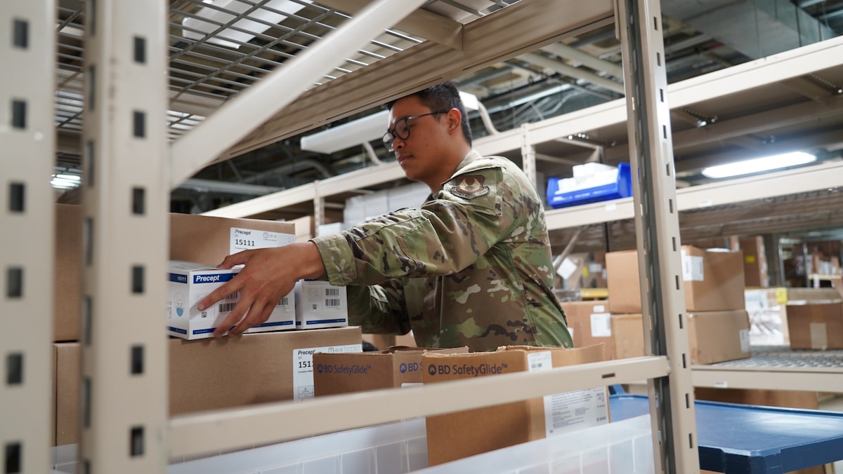 Airman 1st Class Jason Barcelon, 88th Medical Support Squadron medical materiel technician, gathers boxes for shipment in the warehouse at Wright-Patterson Medical Center, June 29, 2023. The squadron’s Medical Logistics and Facilities Flight directly impacts every section, clinic and patient in the Air Force’s second-largest hospital. (U.S. Air Force photo by Kenneth J. Stiles)