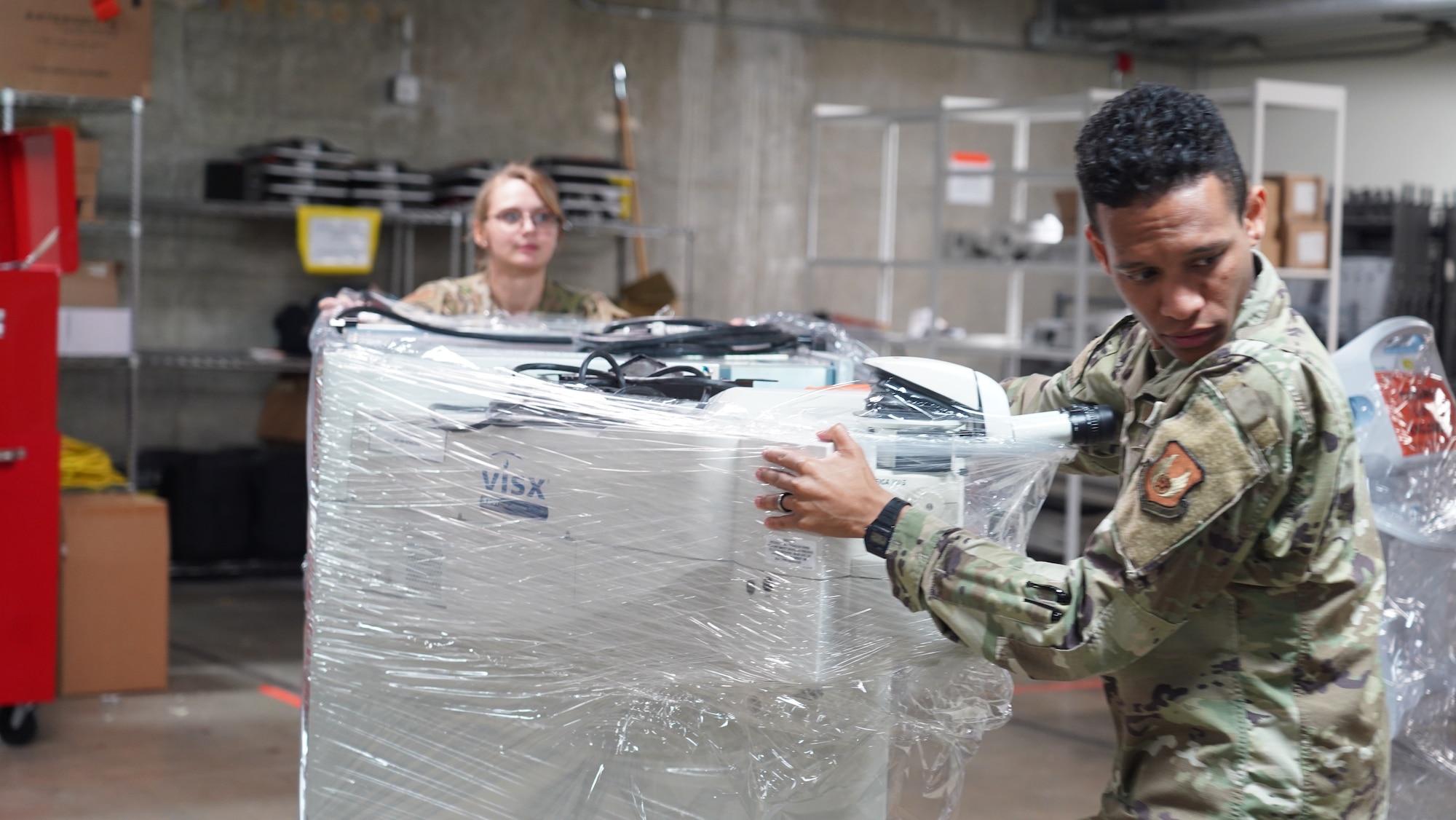 Staff Sgt. Vivian Thompson and Senior Airman John Jackson, both assigned to the 88th Medical Support Squadron as medical materiel technicians, move a pallet of equipment in the warehouse at Wright-Patterson Medical Center, June 29, 2023. The squadron helps “dominate the dirty work” for the 88th Medical Group, keeping daily operations on course while resourcing the Air Force’s second-largest hospital. (U.S. Air Force photo by Kenneth J. Stiles)