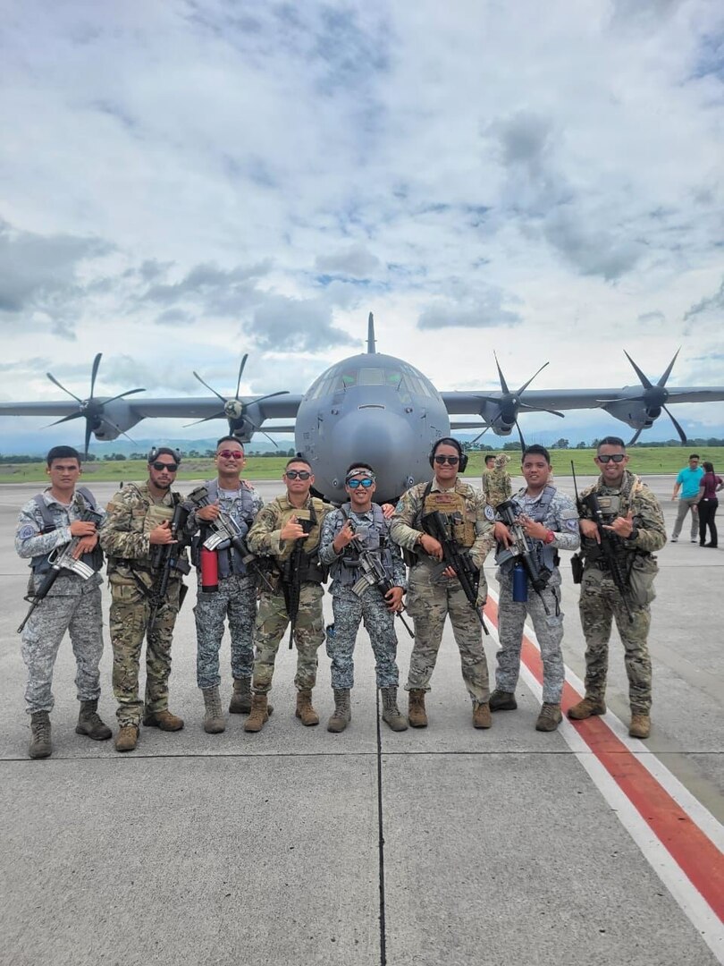 Members of the U.S. Air Force and Philippine Air Force take a photo together in front of a C-130 Hercules at General Santos International Airport, Philippines, July 13, 2023. During Cope Thunder 2-23, members of the 736 SFS assisted the PAF with their first fly-away missions which consist of providing security for aircraft, assets and personnel. (Courtesy Photo)