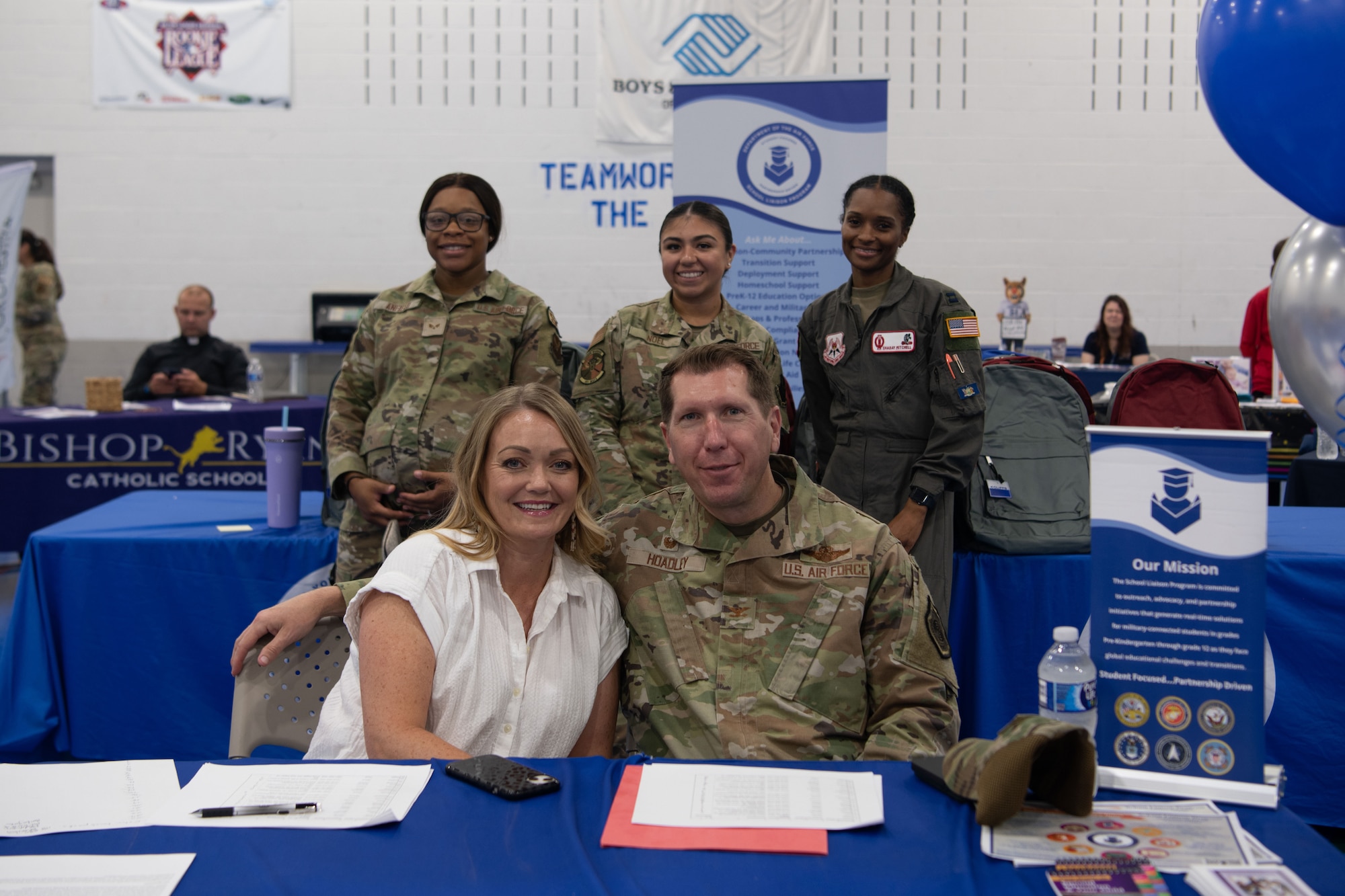 U.S. Air Force Col. Daniel Hoadley, 5th Bomb Wing commander, and Team Minot members pose for a photo at the Operation Homefront Back-to-School Supplies Brigade at Minot Air Force Base, North Dakota, Aug. 4, 2023. The Back-to-School Brigade is a nationwide campaign by Operation Homefront that collects and distributes school supplies to eligible service member dependents. (U.S. Air Force photo by Airman 1st Class Alyssa Bankston)