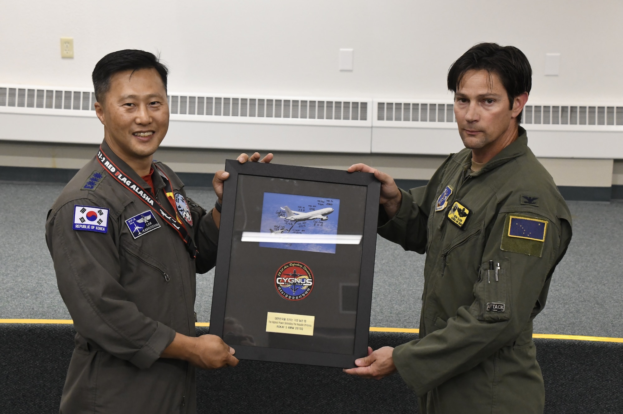 Col. Ronald Oliver, 168th Wing Operations Group commander, is presented a photo plaque during Red Flag Alaska 23-2 from the Republic of Korea Air Force. Members of the 168th Wing and the ROKAF visited together during RF-A 23-2 to exchange tactics and procedures while increasing interoperability on the aerial refueling mission. The multinational exercise allows Air Forces from different countries to integrate and is a testament to the collaborative spirit and shared commitment to maintaining peace and security. The 168th WG and international counterparts provided air power through the aerial refueling mission during RF-A 23-2. Aerial refueling increases combat aircraft’s speed, range, lethality, and versatility. (U.S. Air National Guard photo by Senior Master Sgt. Julie Avey)