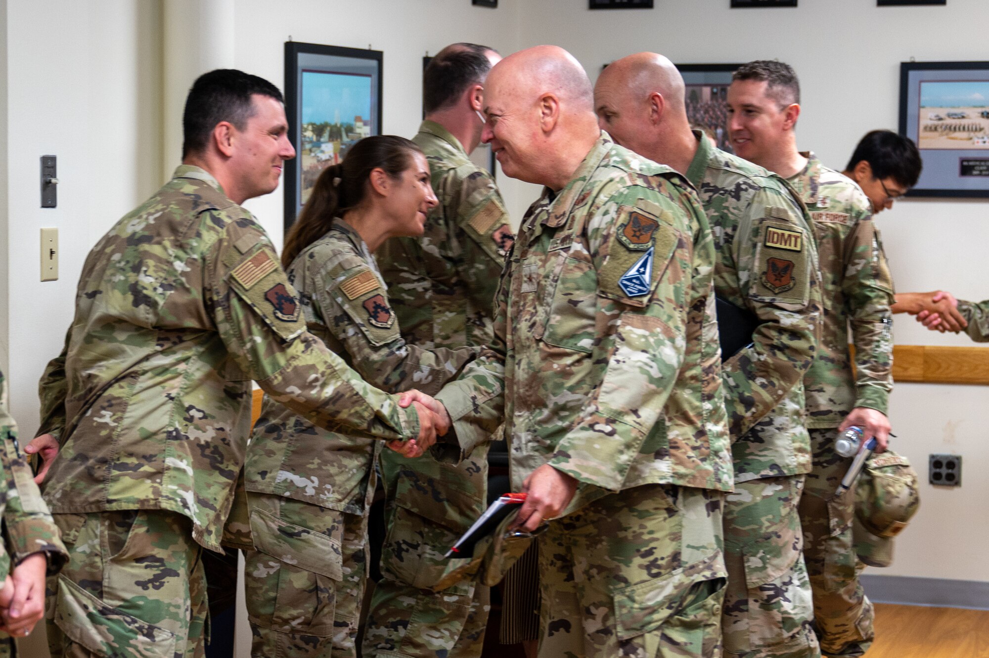 Air Force Medical Readiness Agency commander, presents coins in recognition of 8th Medical Group Airmen’s outstanding performance during his visit to Kunsan Air Base