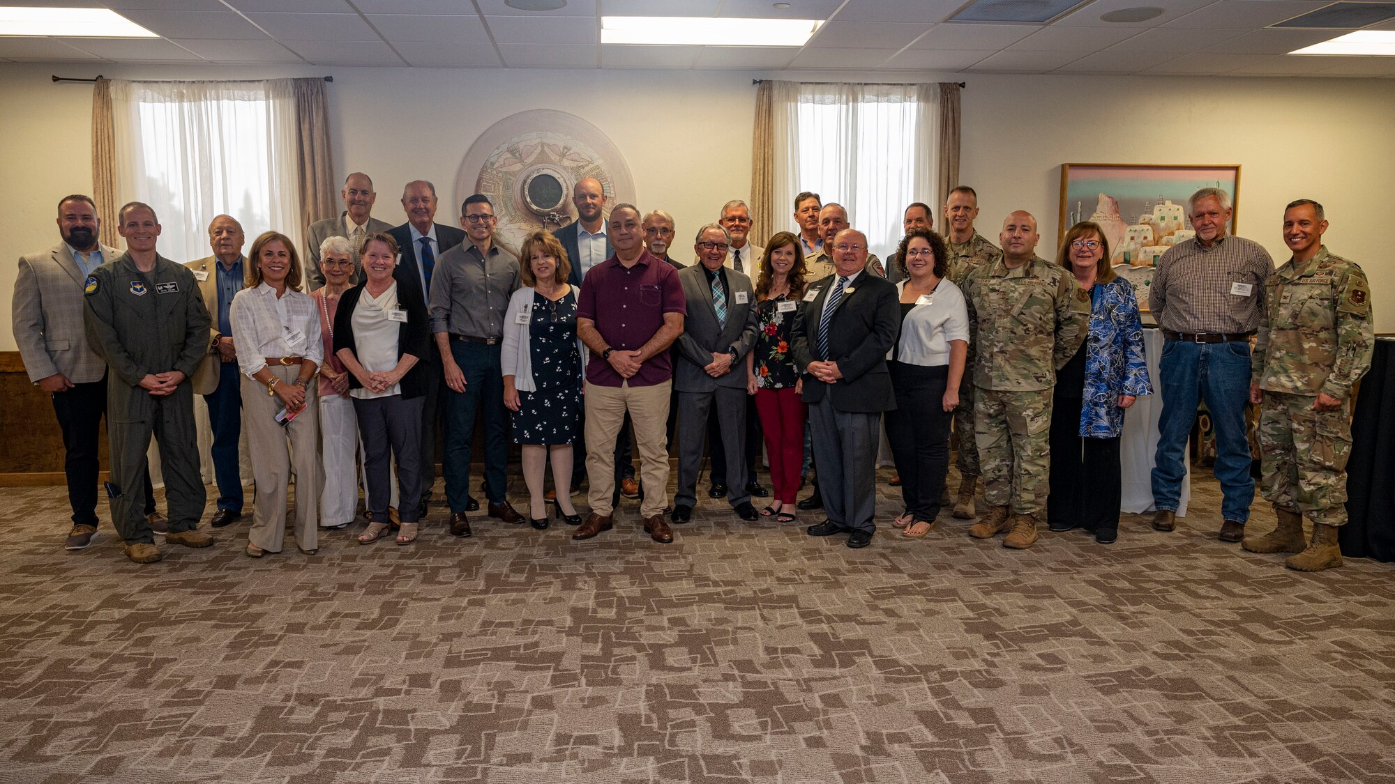 Gilbert R. Cisneros Jr., Under Secretary of Defense for Personnel and Readiness, and  Alex Wagner, Assistant Secretary of the Air Force for Manpower and Reserve Affairs, pose for a photo with community partners from Otero County during a familiarization tour at Holloman Air Force Base, New Mexico, Aug. 1, 2023. Cisneros and Wagner met with community leaders to better understand the current relationship between Holloman and local community members to discuss ways to strengthen the partnership. (U.S. Air Force photo by Airman 1st Class Isaiah Pedrazzini)