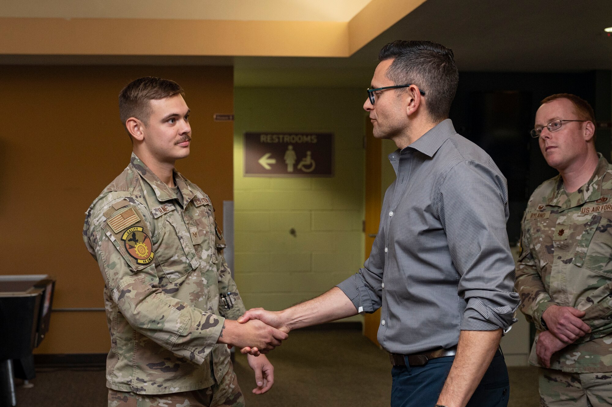 Alex Wagner, Assistant Secretary of the Air Force for Manpower and Reserve Affairs, coins U.S. Air Force Senior Airman Collin Frane, 49th Equipment Maintenance Squadron stockpile crew chief, for his dedication to success in his career field and commitment to Holloman’s mission during a familiarization tour at Holloman Air Force Base, New Mexico, Aug. 1, 2023. This tour provided Wagner and Under Secretary of Defense for Personnel and Readiness Gilbert R. Cisneros Jr. a firsthand look at how Team Holloman operates to ensure that both Airmen and their families have their needs met in order to better the community on base. (U.S. Air Force photo by Airman 1st Class Isaiah Pedrazzini)