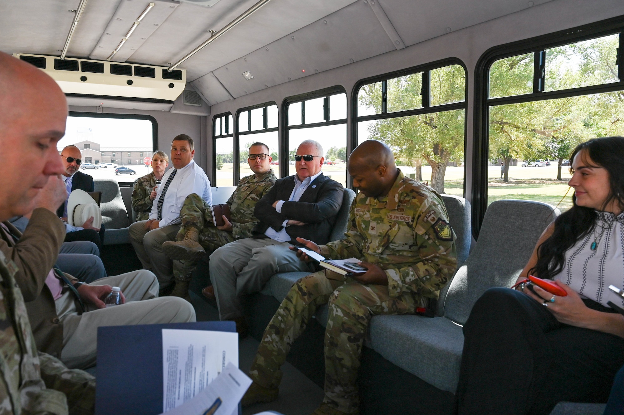 97th Air Mobility Wing leadership discusses the installation with United States Representative Frank Lucas and his team during a tour of the main gate and base housing at Altus Air Force Base (AFB), Oklahoma, Aug. 3, 2023. The tour was an opportunity for base leadership and Lucas to discuss progress updates and infrastructure goals around base. (U.S. Air Force photo by Airman 1st Class Heidi Bucins)