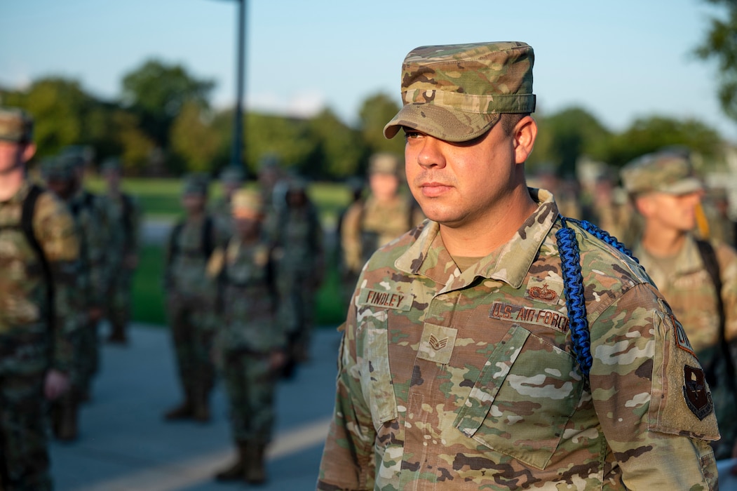 U.S. Air Force Staff Sgt. Austin Findley, 335th Training Squadron master military training leader, oversees Airmen marching at Keesler Air Force Base, Mississippi, August 2, 2023. Findley deployed to Iraq twice at ages 19 and 20 in his career of pavement and construction equipment operation. (U.S. Air Force photo by Airman 1st Class Trenten Walters)