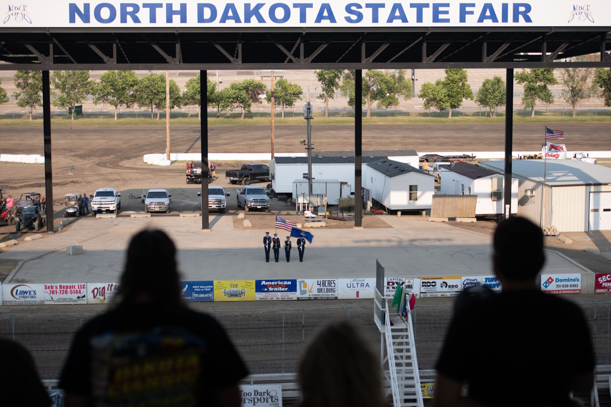 Minot Air Force Base Honor Guardsmen perform at the North Dakota State Fairgrounds during a racing event at Minot, North Dakota, July 9, 2023. The Honor Guardsmen presented the colors while the national anthem played before the race. (U.S. Air Force photo by Airman 1st Class Trust Tate)