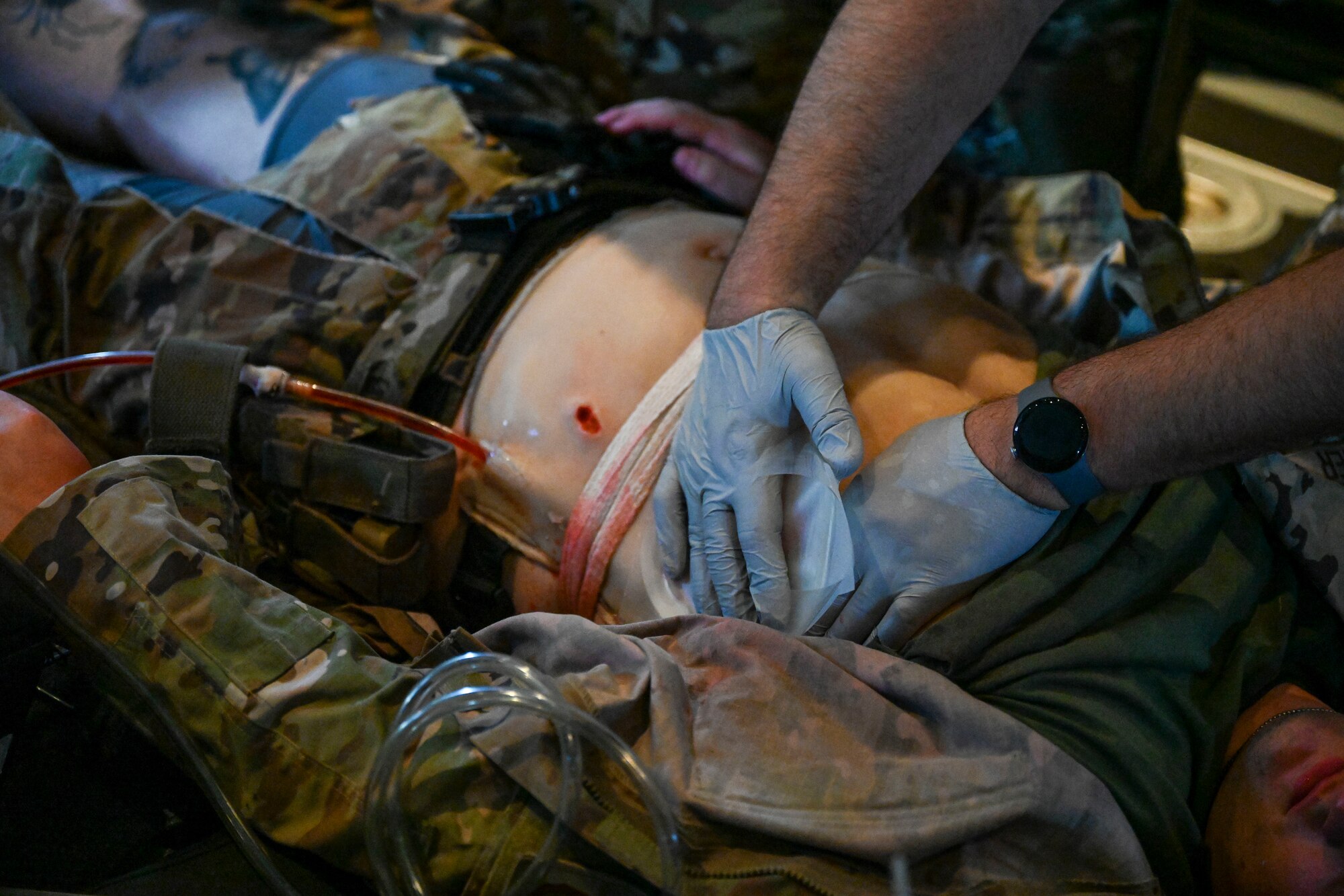 An Airman with the 445th Aeromedical Evacuation Squadron provides inflight care to a simulated patient as part of a mass casualty training scenario