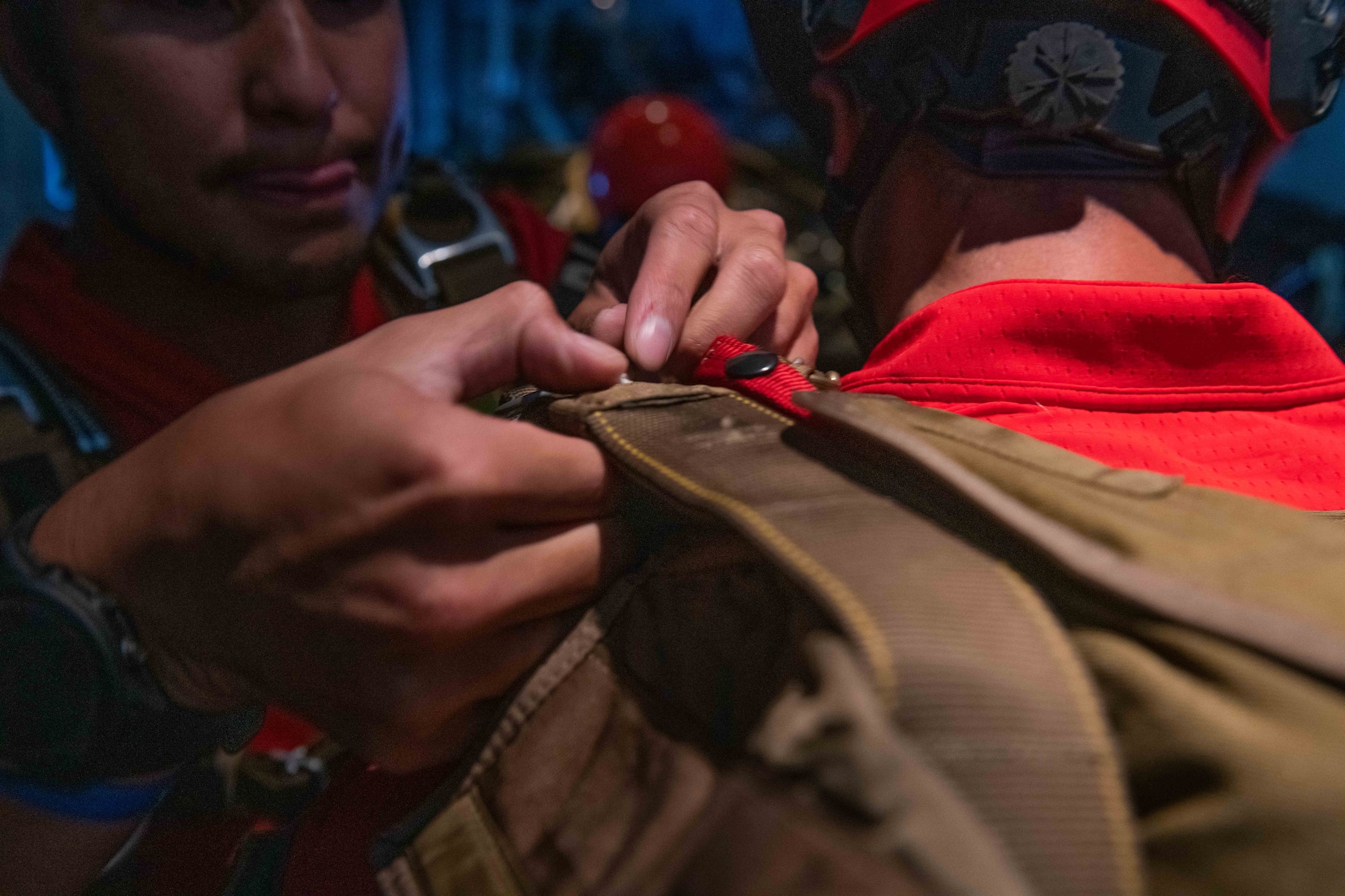 U.S. Air Force pararescuemen assigned to the 31st Rescue Squadron check each other's equipment before jumping out of a HC-130J Super Hercules for water rescue training off the shores of Okinawa, Japan, July 20, 2023. HC-130J crews executed search operations to find multiple patients afloat, employ pararescuemen, rescue craft to secure patients and provide medical treatment while waiting for extraction via HH-60G Pavehawks. (U.S. Air Force photo by Senior Airman Cedrique Oldaker)