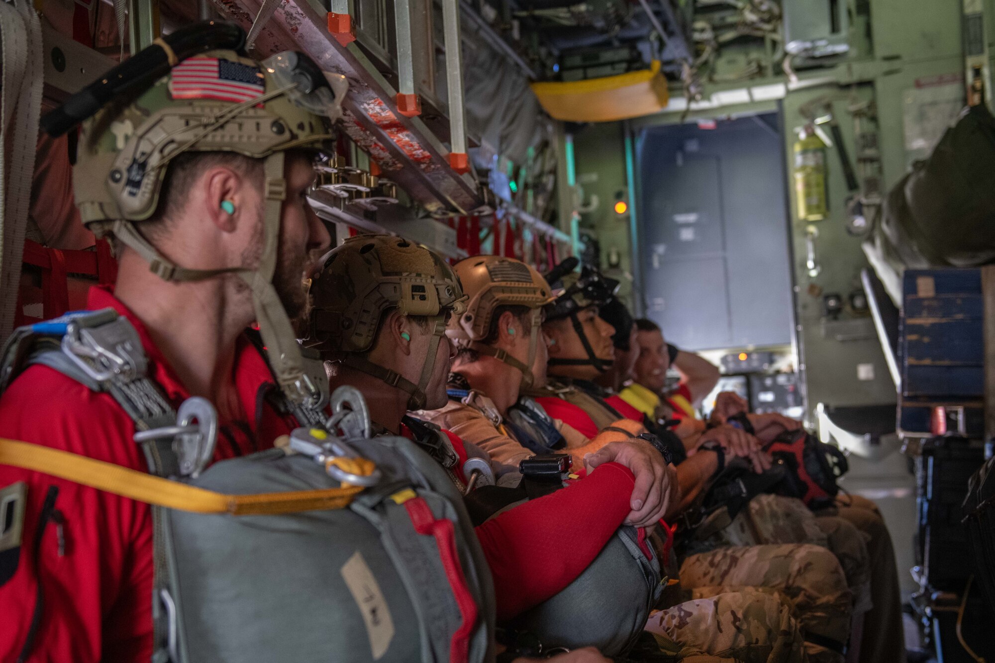 U.S. Air Force pararescuemen assigned to the 31st Rescue Squadron prepare to jump from a HC-130J Super Hercules for water rescue training with 79th RQS from Davis-Monthan Air Force Base and the 33rd RQS off the shore of Okinawa, Japan, July 20, 2023. With no HC-130J assigned to Kadena AB, this provided a rare opportunity for rescue forces to rehearse operations with all three legs of the rescue triad, the Guardian Angels, HH-60 Pavehawks and HC-130J Super Hercules. (U.S. Air Force photo by Senior Airman Cedrique Oldaker)
