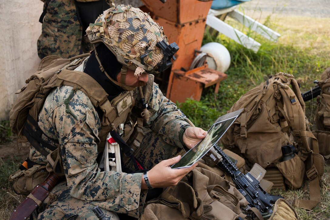 U.S. Marine Corps Cpl. Benjamin Rodriguez, a student in the Advanced Infantry Marine Course with Advanced Infantry Training Battalion, School of Infantry-West, Hawaii Detachment, reviews a map before urban operations training, Marine Corps Training Area Bellows, July 11, 2023. The training was conducted as part of the Advanced Infantry Marine Course. AIMC is designed to enhance and test Marines’ skills with a focus on reinforcing proper patrols and operational procedures. (U.S. Marine Corps photo by Cpl. Chandler Stacy)
