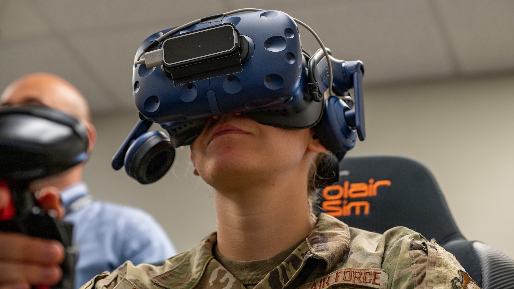 Air Force ROTC Academy Cadet Hannah Cunningham learns how to fly an F-15E Strike Eagle in a virtual reality training simulation at Seymour Johnson Air Force Base, North Carolina, August 3, 2023. Under the guidance of Capt. Victoria Beck, 334th Fighter Squadron weapons safety officer and Capt. Cecilia “Feisty” Tuma, a pilot assigned to the 333rd Fighter Squadron, the cadets attempted to take-off, attack both airborne and land targets and land during the simulation. (U.S. Air Force photo by Airman 1st Class Leighton Lucero)