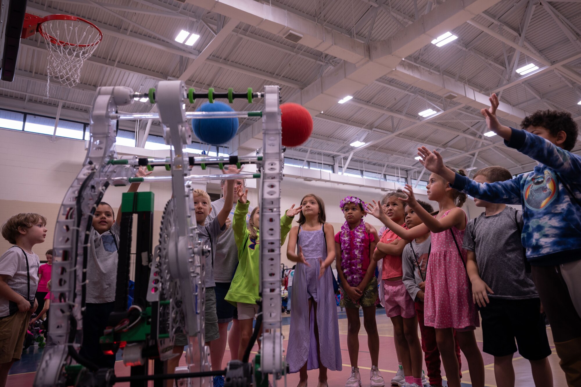 Students from the Wayne County community catch basketballs launched by the First Robotics Team’s robot during Inspire 4th at Seymour Johnson Air Force Base, North Carolina, Aug. 4, 2023. Inspire 4th was part of Project Quesada which is an Air Combat Command initiative to identify opportunities to partner with Hispanic serving institutions and other minority serving institutions, as well as expose and inspire science, technology, engineering and math students to careers within ACC. (U.S. Air Force photo by Airman 1st Class Rebecca Sirimarco-Lang)