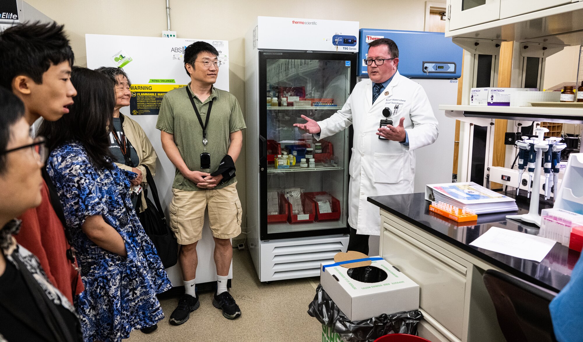 Jeff Walterscheid, right, Armed Forces Medical Examiner System chief toxicologist, briefs Massachusetts Institute of Technology alumni on the toxicology section during a tour on Dover Air Force Base, Delaware, Aug. 4, 2023. Members of the MIT Sloan Club of New York and MIT Club of New York were given the opportunity to visit AFMES, Air Force Mortuary Affairs Operations and the Bedrock Innovation Lab on Dover AFB. (U.S. Air Force photo by Staff Sgt. Marco A. Gomez)