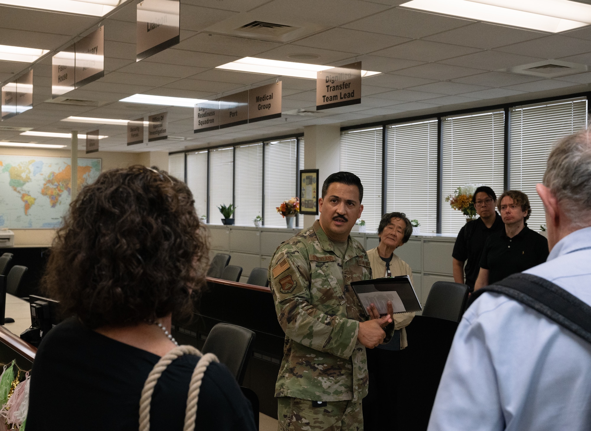 Tech. Sgt. Robin Strickland, Air Force Mortuary Affairs Operations Public Affairs noncommissioned officer in charge, provides an overview of AFMAO Command, Control and Communications to visitors from the Massachusetts Institute of Technology Sloan Club of New York and MIT Club of New York during a tour at Dover Air Force Base, Delaware, Aug. 4, 2023. C3 tracks human remains from overseas to final resting place. (U.S. Air Force photo by Staff Sgt. Andrew J. Alvarado)