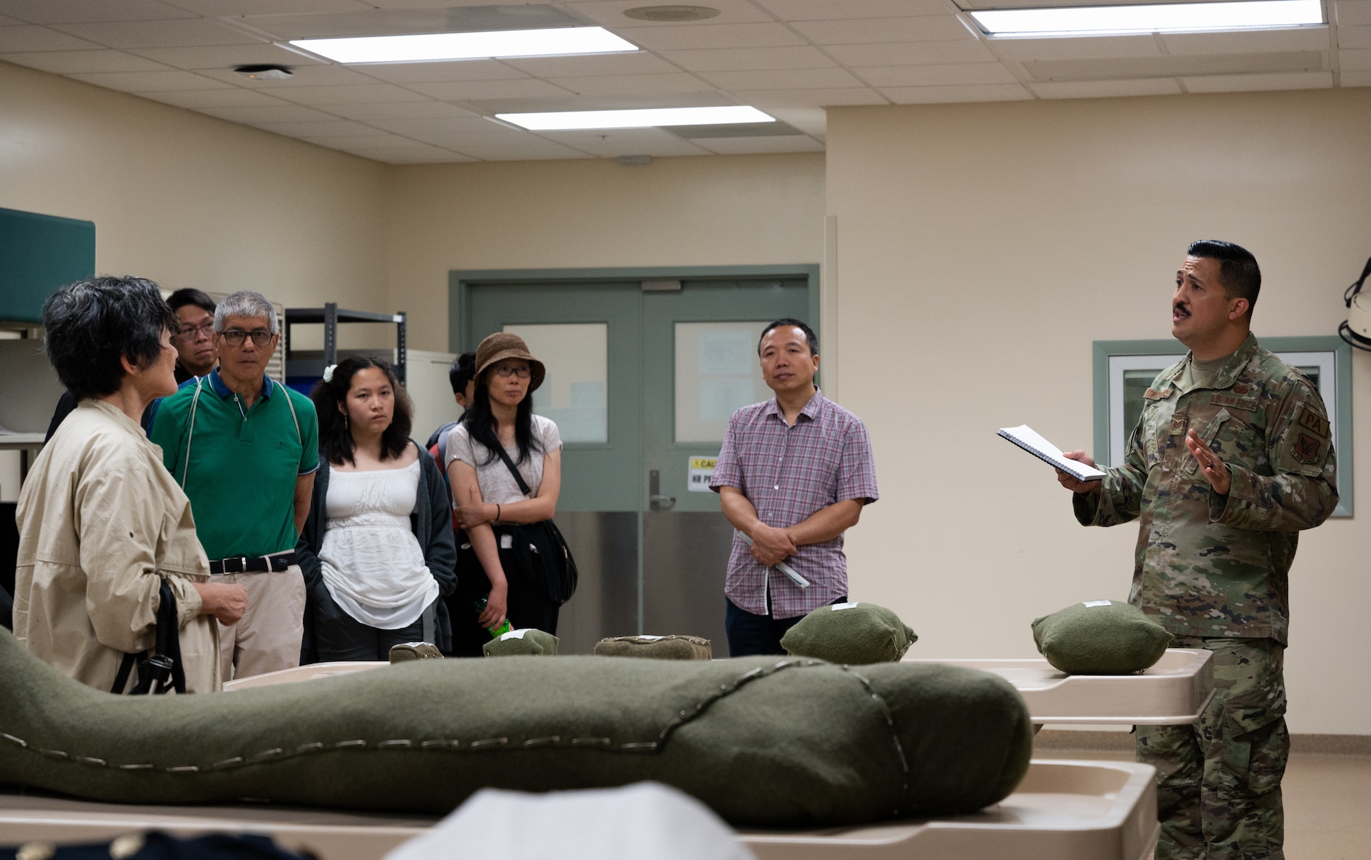 Tech. Sgt. Robin Strickland, Air Force Mortuary Affairs Operations Public Affairs noncommissioned officer in charge, explains the different levels of viewability for remains to Massachusetts Institute of Technology alumni during their visit to Dover Air Force Base, Delaware, Aug. 4, 2023. The visitors learned how AFMAO cares for the fallen and their families during their orientation. Members of the Massachusetts Institute of Technology Sloan Club of New York and MIT Club of New York were given the opportunity to visit AFMES, Air Force Mortuary Affairs Operations and the Bedrock Innovation Lab on Dover AFB. (U.S. Air Force photo by Staff Sgt. Andrew J. Alvarado)