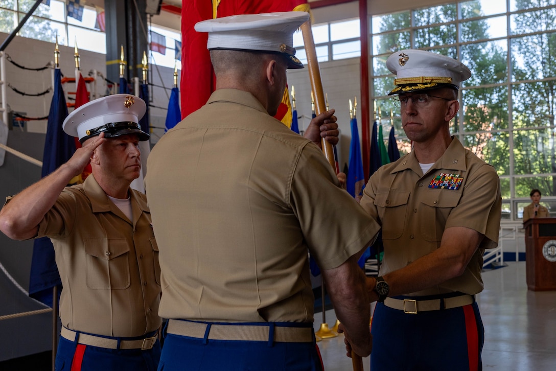 U.S. Marine Corps Col. Joel C. Schumacher, the outgoing 9th Marine Corps District commanding officer, passes the colors to Col. Aaron C. Lloyd, the oncoming commanding officer, during a change of command ceremony at Naval Station Great Lakes, July 18, 2023. The change of command ceremony serves as the official changeover between commanding officers, honoring the outgoing officer’s contributions to the unit while offering the opportunity for the oncoming officer to introduce himself to the Marines now under his charge. (U.S. Marine Corps photo by Lance Cpl. Reine Whitaker)