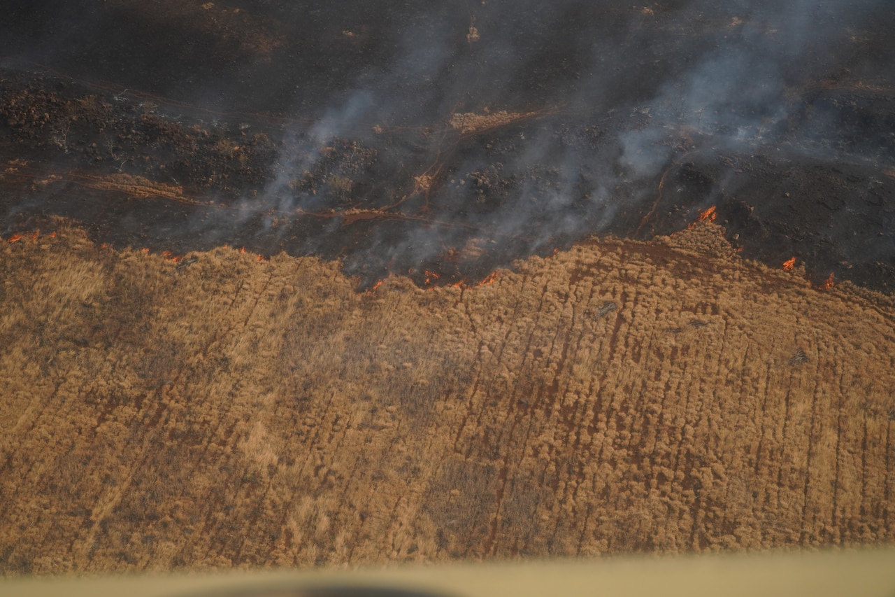 An aerial view from a military aircraft of a wildfire burning in Hawaii.
