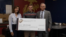 U.S. Marine Corps applicant John Arnold, a Naval Reserve Officer Training Corps (NROTC) scholarship recipient out of Marine Corps Recruiting Sub-Station Saint Charles, Recruiting Station Chicago, poses for a photo with his family at RSS St. Charles, Naperville, IL, June 13, 2023. Arnold plans to attend the University of Mississippi before commissioning as a Marine Corps Officer. Students selected for this prestigious scholarship program must uphold strict physical fitness standards and successfully complete additional military courses while maintaining normal college coursework responsibilities. (U.S. Marine Corps photo by Sgt. Dalton J. Payne)