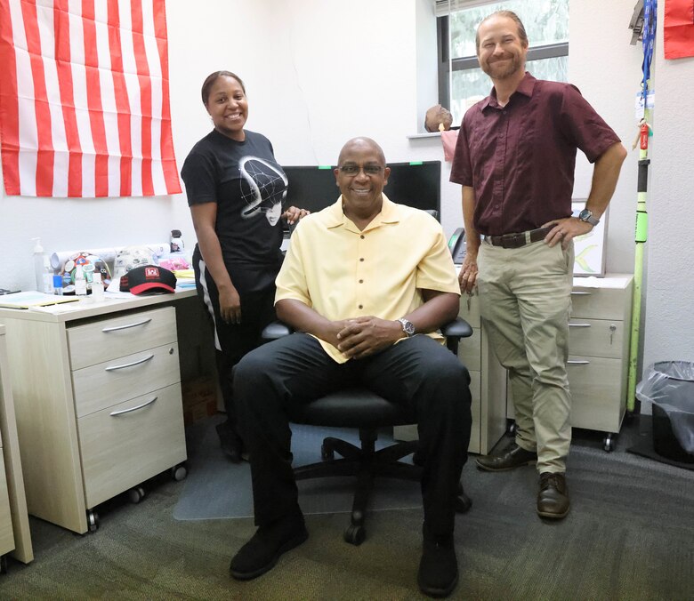 Mark White, U.S. Army Corps of Engineers Panama City Site Office lead civil engineer, seated, poses for a photo with Rhashana Williams, administrative assistant, and Waylon Register, Panama City Site Manager, at the site office in Panama City, Florida, July 13, 2023. White will be retiring after almost 40 years of service to the Mobile District, the Panama City Site Office, and the Corps later this fall. (U.S. Army photo by Chuck Walker)