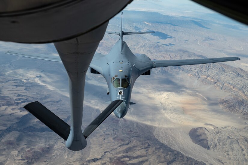 A jet prepares to be refueled in midair.