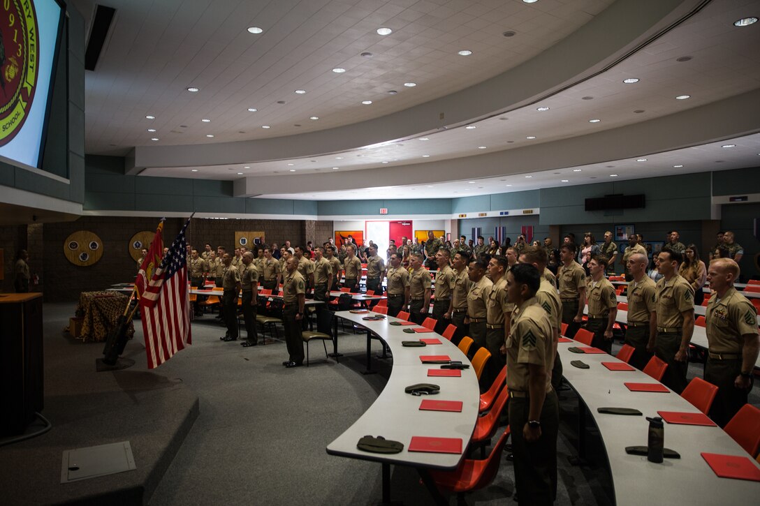 U.S. Marines with the Combat Instructor School Class 4-19, School of Infantry - West, sing “The Marines’ Hymn,” during a graduation ceremony on Marine Corps Base Camp Pendleton, California, Sept. 12, 2019. The mission of CIS is to develop Marines’ leadership, character, knowledge and fitness to fortify them with skills required to succeed as a combat instructors. CIS is a nine-week course that provides Marines with knowledge of the rules, regulations and procedures to prepare them to lead and instruct entry-level Marines during combat training. (U.S. Marine Corps photo by Lance Cpl. Alison Dostie)