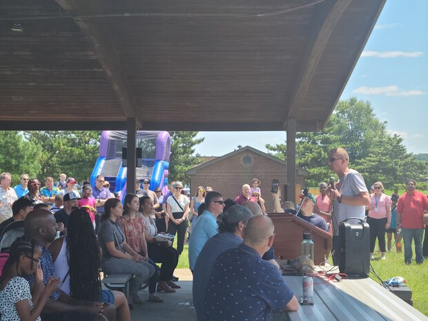 Photo shows Vice Admiral Johnny R. Wolfe, Jr, Director Strategic Systems Programs (SSP) giving remarks from a podium to thank the workforce for their hard work at the SSP command picnic at Joint Base Anacostia-Bolling. The command picnic was organized by SSP’s Activity and Recreations Committee and offered personnel and their families an opportunity to boost camaraderie and participate in various outdoor activities. (U.S. Navy photo by Shelby Thompson/Released)