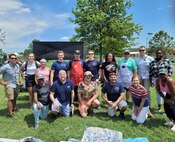 Volunteers with SSP’s Activity and Recreations Committee pose for a group photo outside at the SSP command picnic at Joint Base Anacostia-Bolling. The command picnic was organized by SSP’s Activity and Recreations Committee and offered personnel and their families an opportunity to boost camaraderie and participate in various outdoor activities. (U.S. Navy photo/Released)