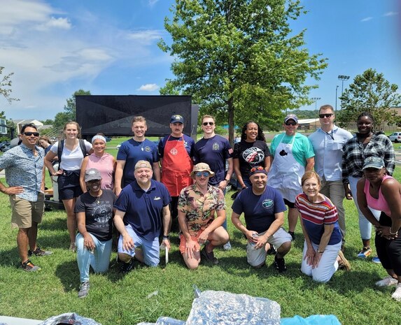 Volunteers with SSP’s Activity and Recreations Committee pose for a group photo outside at the SSP command picnic at Joint Base Anacostia-Bolling. The command picnic was organized by SSP’s Activity and Recreations Committee and offered personnel and their families an opportunity to boost camaraderie and participate in various outdoor activities. (U.S. Navy photo/Released)