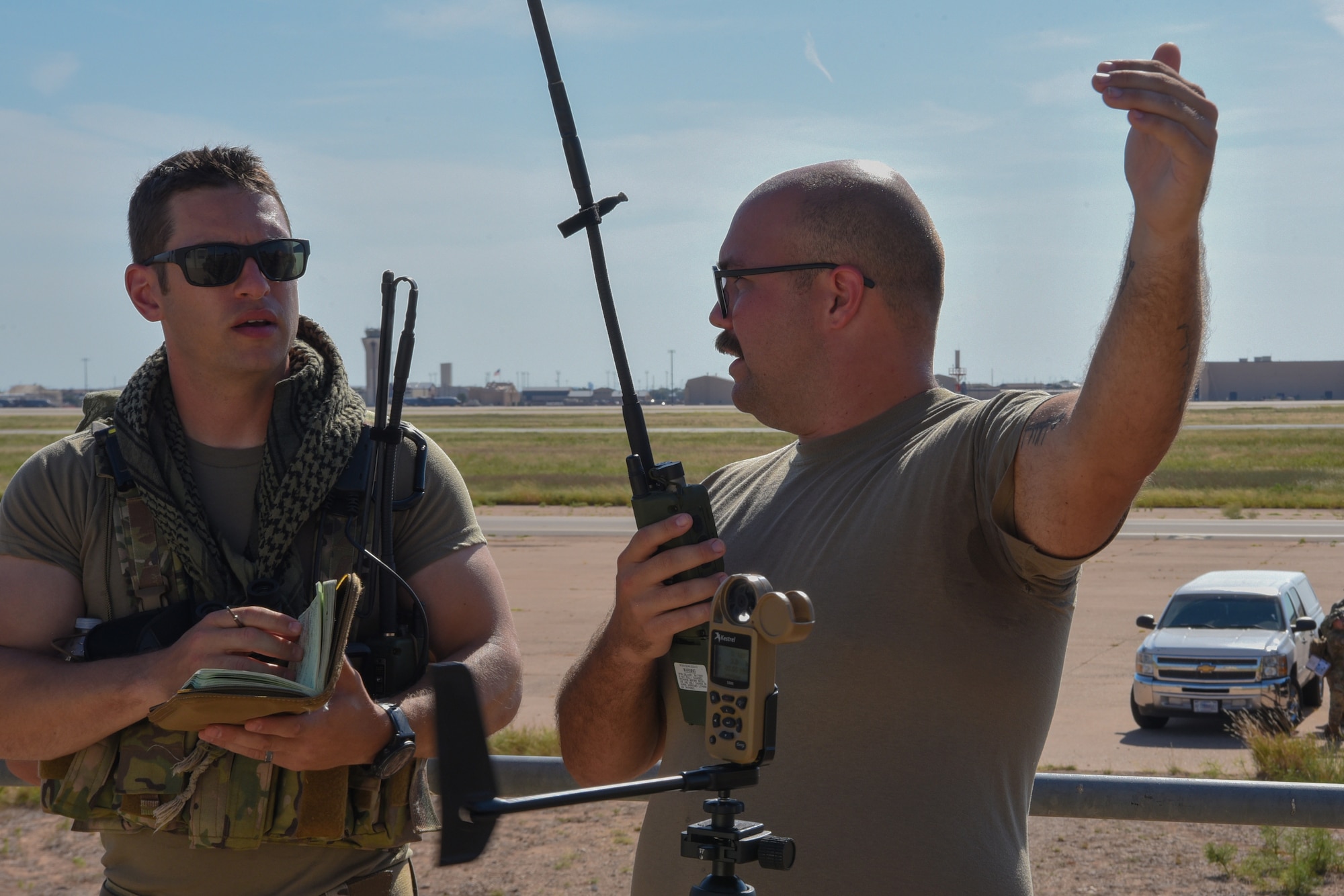 Master Sgt. Levi Rodney, 435th Training Squadron Landing Zone Safety Officer course instructor, engages with Tech. Sgt. Dylan Mullen, 7th Operations Support Squadron airfield management operations supervisor, at Dyess Air Force Base, Texas, Aug. 2, 2023. Airmen within the LZSO course learned skills that combat controllers use in austere environments, such as establishing small landing surfaces and controlling aircraft for landing. (U.S. Air Force photo by Senior Airman Sophia Robello)