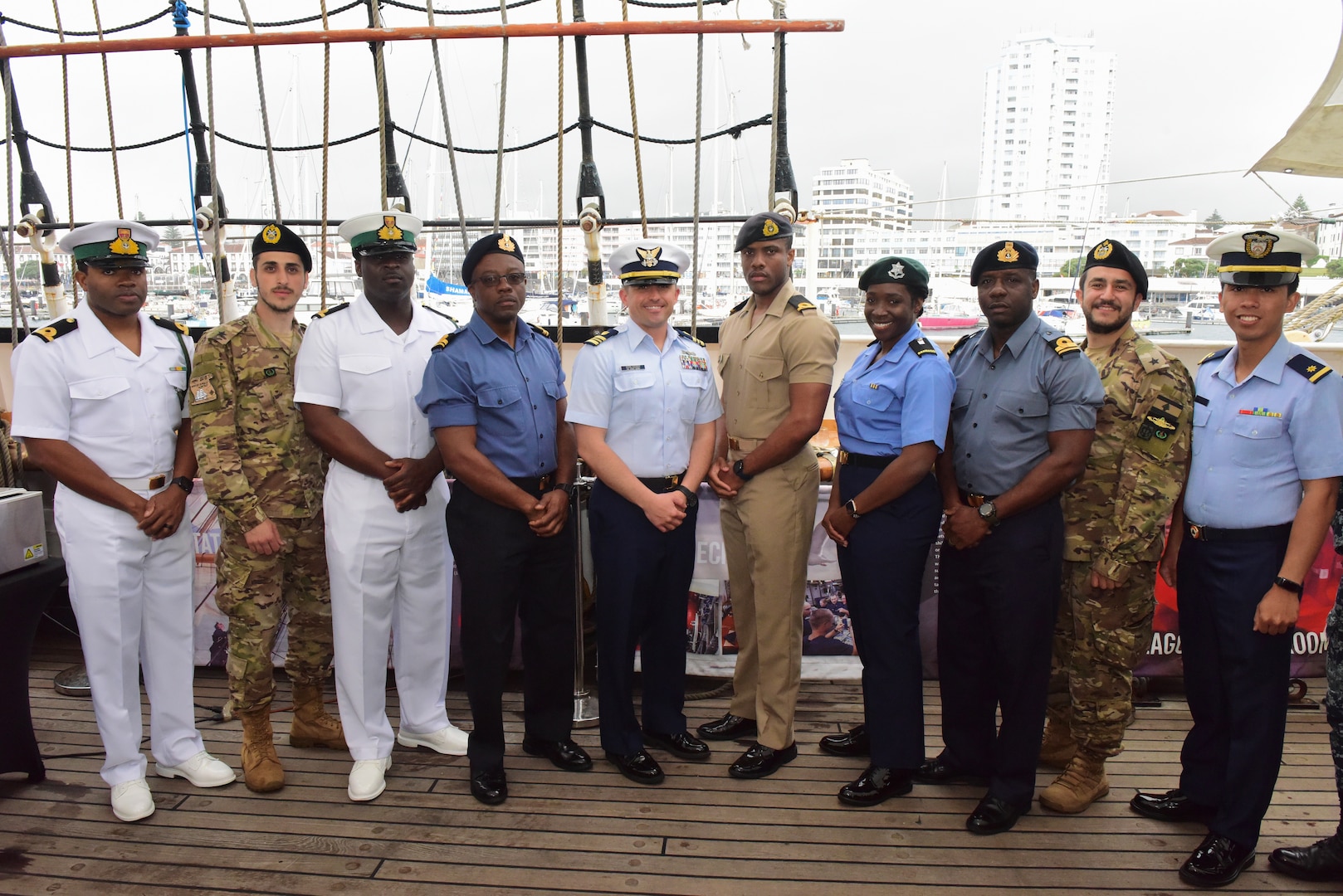 Foreign military personnel embarked aboard the USCGC Eagle (WIX 327) for its 2-week officer candidate school cruise pose for a group photo during a reception aboard Eagle, April 22, 2023, while moored in Ponta Delgada, Azores; from left to right: Sub-Lt. Oneil Campbell, Royal Bahamas Defence Force, Sub-Lt. Ahmad Dahboul, Lebanese Navy, Lt.j.g. Javano Edgecombe, Royal Bahamas Defense Force, Lt. George Lightfoot, Jamaican Defense Force, Lt. Cmdr. Joseph Schlosser, U.S. Coast Guard Direct Commission Officer Course, Chief, at the Leadership Development School, Sub-Lt. Davian Pryce, Jamaica Defence Force Coast Guard, Midshipman Kimberly Gittens, Barbados Defence Force, Lt. Elvardo Knowles, Royal Bahamas Defence Force, Sub. Lt Tony Abi Ramia, Lebanese Navy, and Ensign Ivanher Teyab, Philippine Coast Guard. Eagle conducted a four-month summer deployment to teach practical seamanship skills to officer candidates from the U.S. Coast Guard and National Oceanic and Atmospheric Administration Corps, foreign military personnel, and shared best practices with sailing organization Tall Ships America, while cadets and crew facilitated diplomatic engagements with U.S. allies in Northern Europe, the Portuguese archipelagos of the Azores and Madeira, and Bermuda. (U.S. Coast Guard photo by Petty Officer 2nd Class Brandon Hillard)