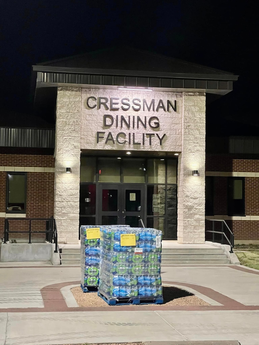 Water sits outside of the Cressman Dining Facility after being distributed across Goodfellow Air Force Base, Texas, July 19th, 2023. Immediately after the boil-water advisory was announced, multiple 17th Logistics Readiness Squadron personnel responded by disturbing pallets of water across Goodfellow to maintain mission readiness. (Courtesy photo)