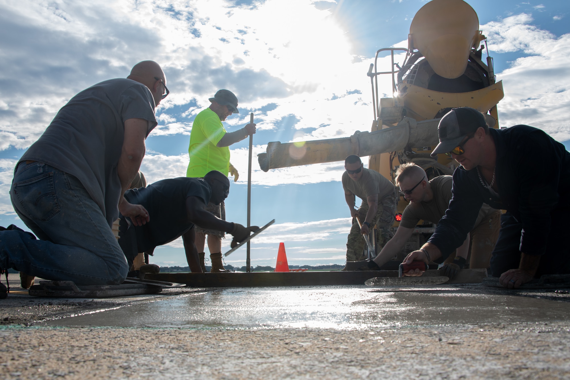 Members with the 316th Civil Engineer Squadron, known as 'Dirt Boys,' finish smoothing over concrete for repairs on the flightline at Joint Base Andrews, Maryland, Aug. 8, 2023.