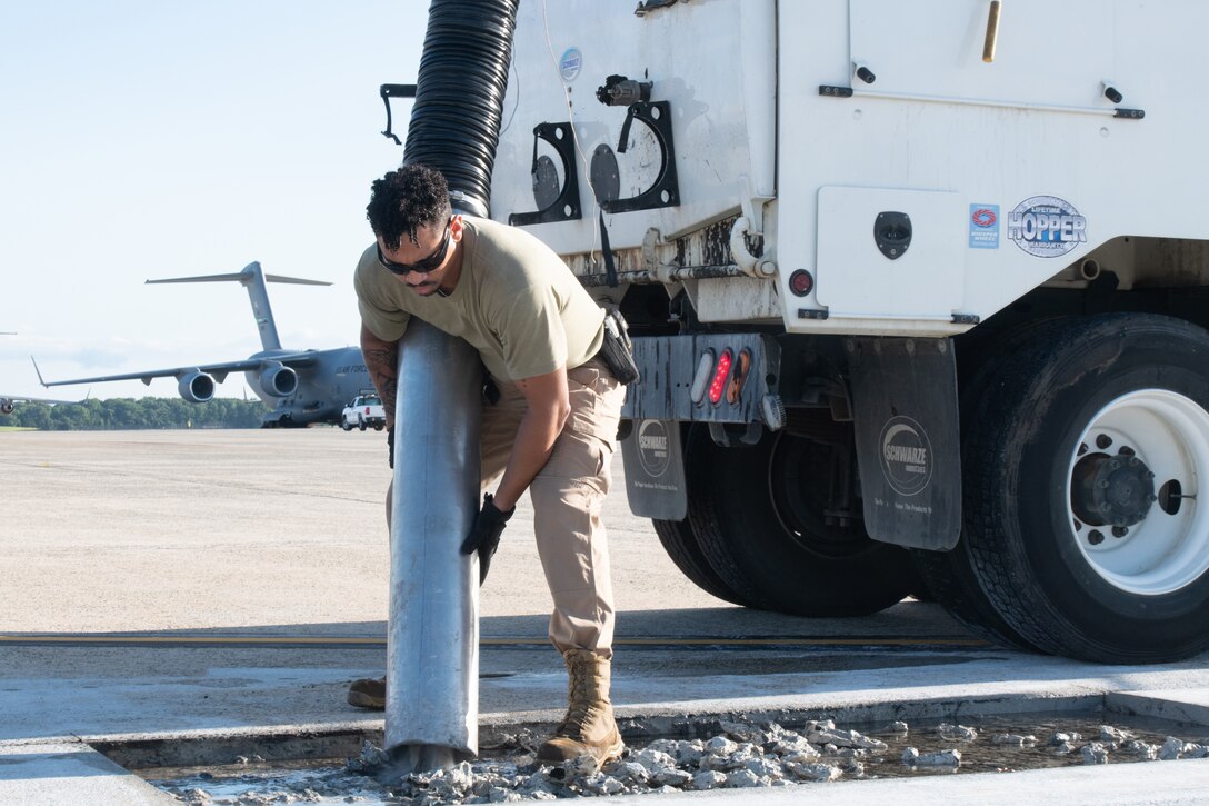 Senior Airman Bryce Jackson, 316th Civil Engineer Squadron heavy equipment journeyman, uses a vacuum truck to remove rainwater from a construction site on the flight line at Joint Base Andrews, Maryland, Aug. 8, 2023.