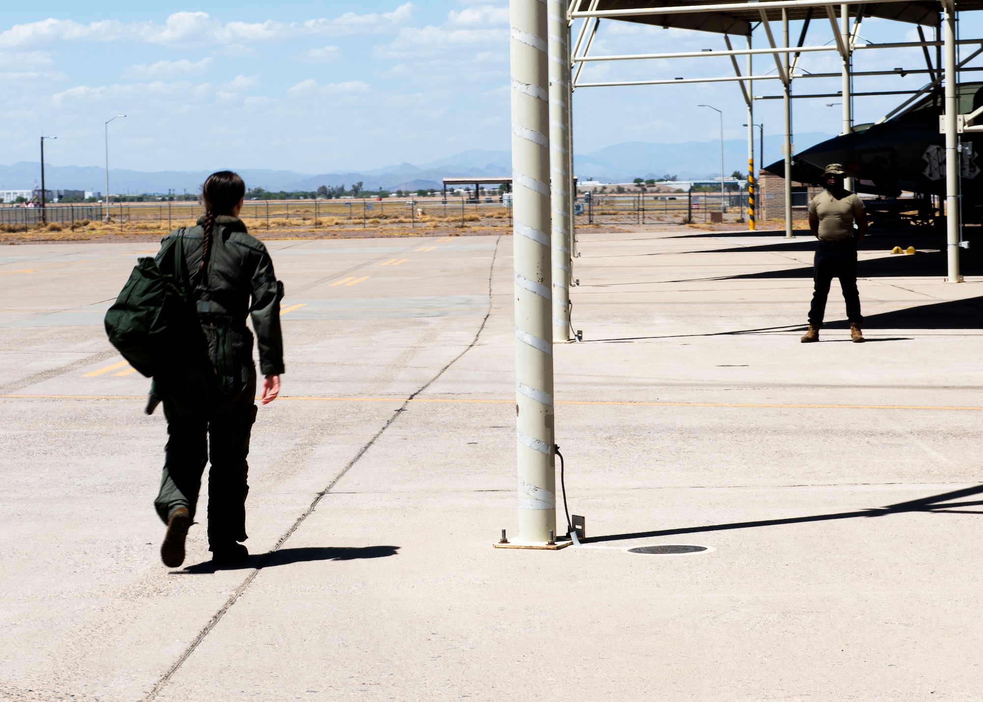 U.S. Air Force Capt. Audrey Wilson, 56th Training Squadron student pilot, walks across the flightline to begin her mission Aug. 3, 2023, at Luke Air Force Base, Arizona.