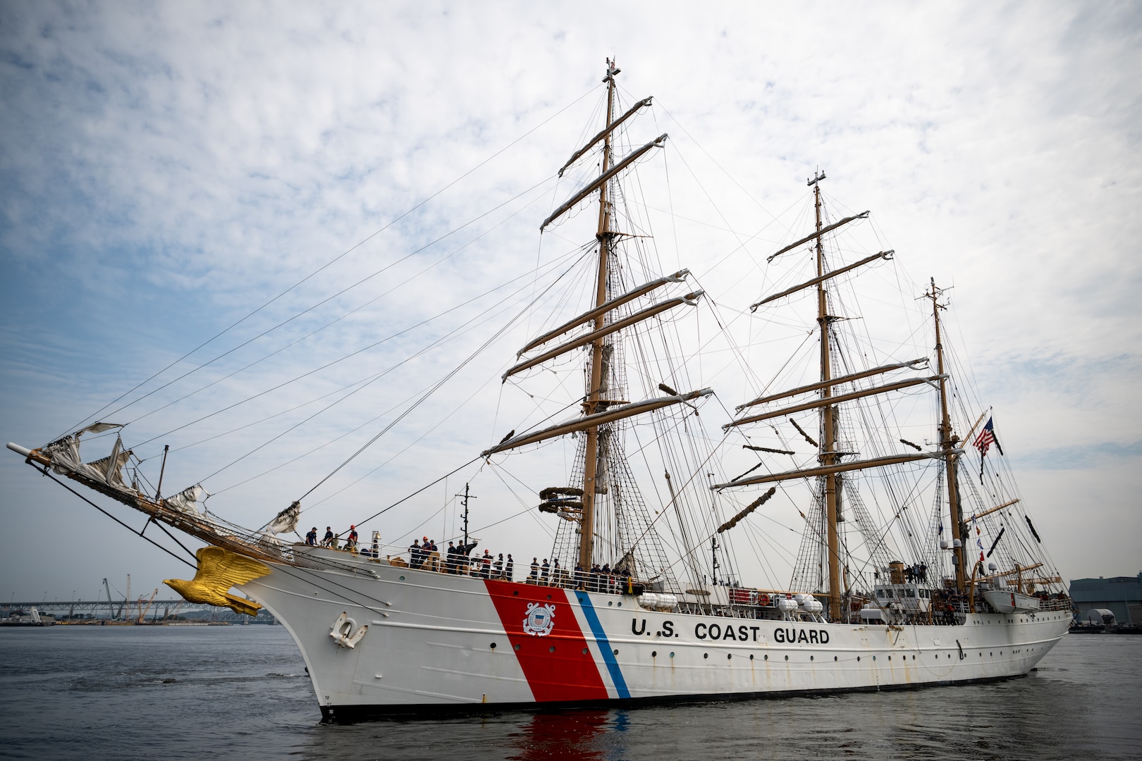 The crew of the Coast Guard Barque Eagle (WIX 327) returns to homeport in New London, August 10, 2023. This year, crew, cadets, and officer candidates sailed over 16,800 nautical miles, traveling to the Azores, Netherlands, Norway, Denmark, Finland, and Sweden as part of their annual training cruise, after departing New London, April 8, 2023. (U.S. Coast Guard Photo by Petty Officer 2nd Class Taylor Bacon)