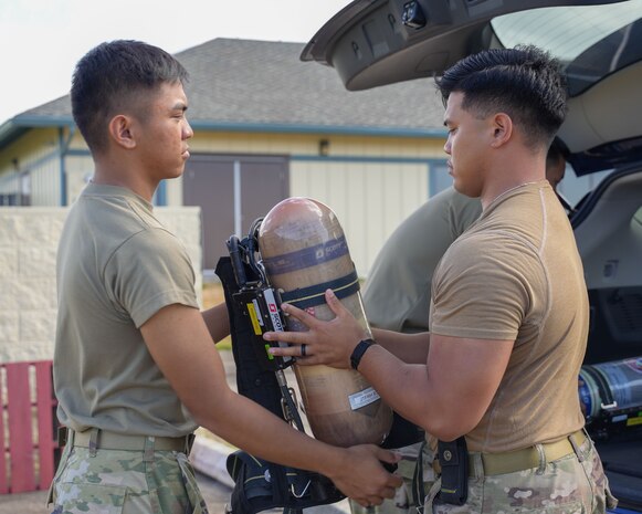 Joint Task Force-Red Hill (JTF-RH) roving security and fire watch team members unload air tanks for Self-Contained Breathing Apparatus (SCBA) training on Ford Island, Honolulu, Hawaii, August 8, 2023. JTF-RH is in phase three of its five-phase defueling plan. Personnel are focused on completing quality control tasks, training, response preparation, the National Environmental Policy Act Environmental Assessment, regulatory approvals and operational planning for all major milestones. This extensive preparatory work will help ensure the safe and expeditious defueling of the Red Hill Bulk Fuel Storage Facility. (DoD photo by U.S. Marine Corps Cpl. Gabrielle Zagorski)